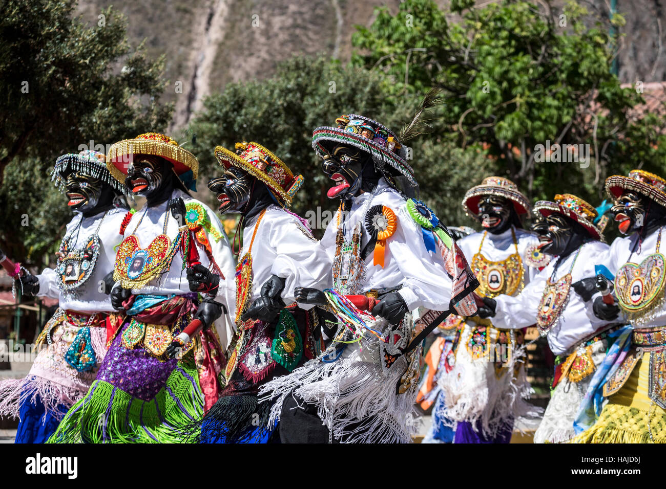 Men wearing colorful costumes during religious procession, Ollantaytambo, Cusco, Peru Stock Photo