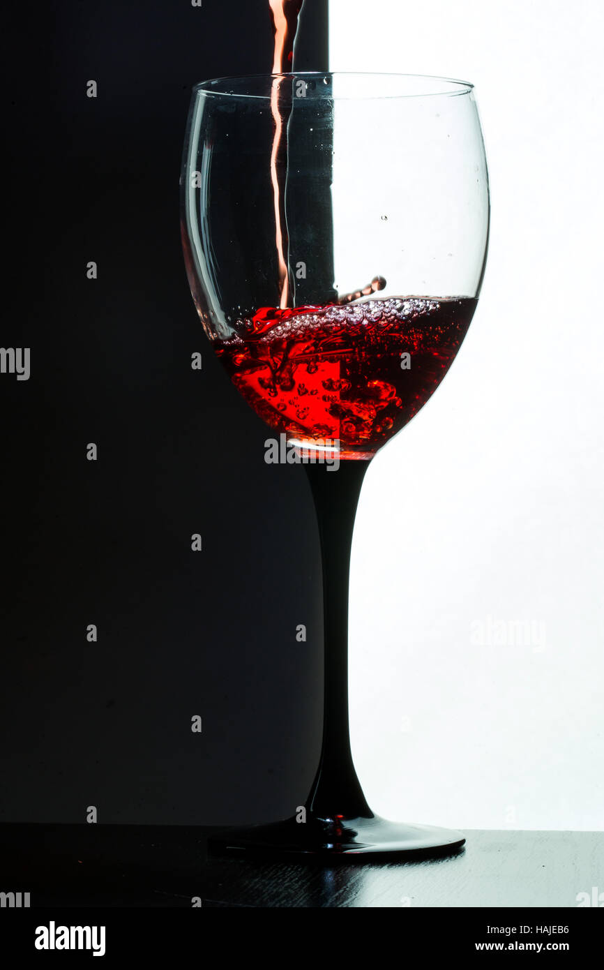 Red wine pouring. white on black background Stock Photo Alamy