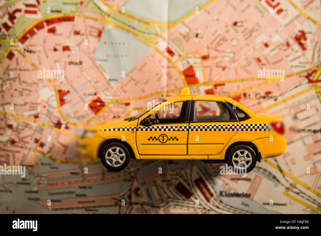 map and yellow taxi car  - travel background. auto lie on paper urban card Stock Photo