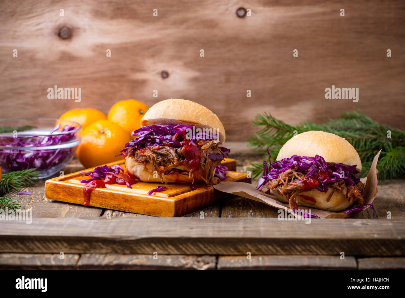 Homemade bbq beef burger with crunchy red cabbage slaw on rustic table
