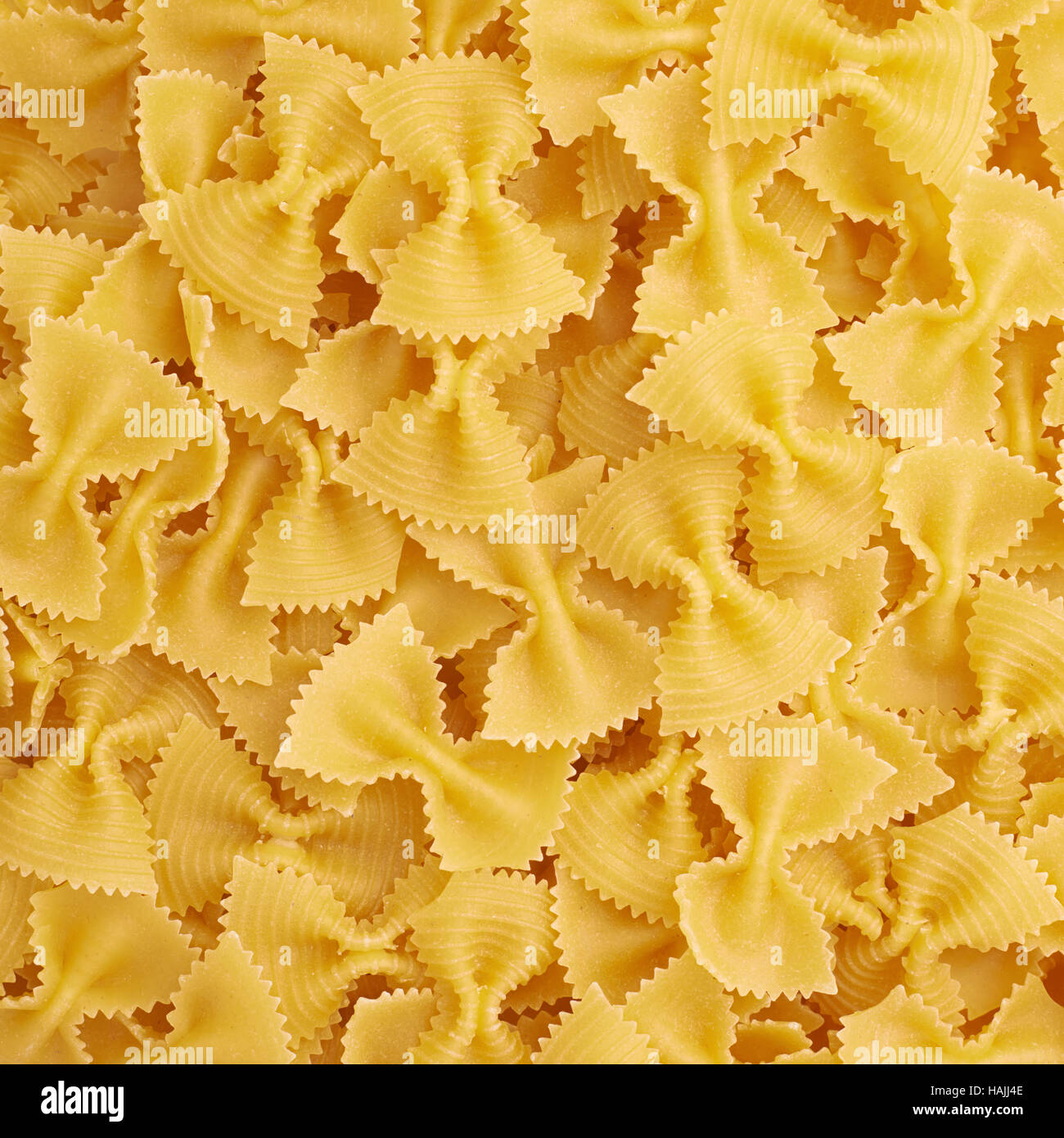 Download Pile Of Farfalle Yellow Pasta As Abstract Background Stock Photo Alamy PSD Mockup Templates