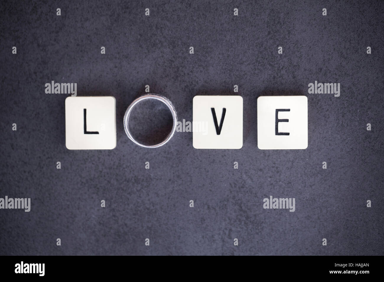 Letter tiles and ring spelling the word 'LOVE'. Conceptual picture for love, wedding, mariage, engagement, etc... Stock Photo