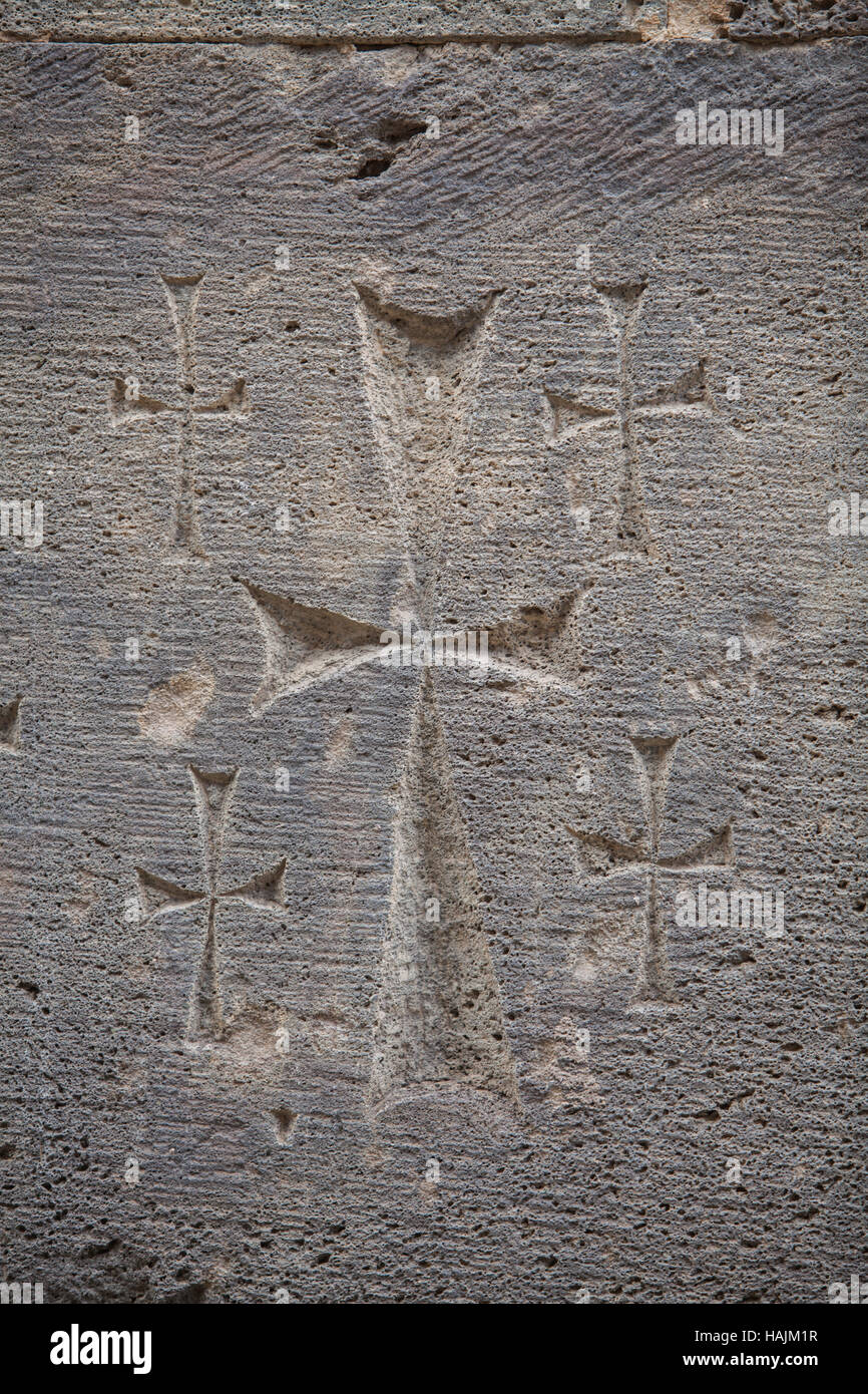 Close up shot of a cross carved in a stone. Stock Photo
