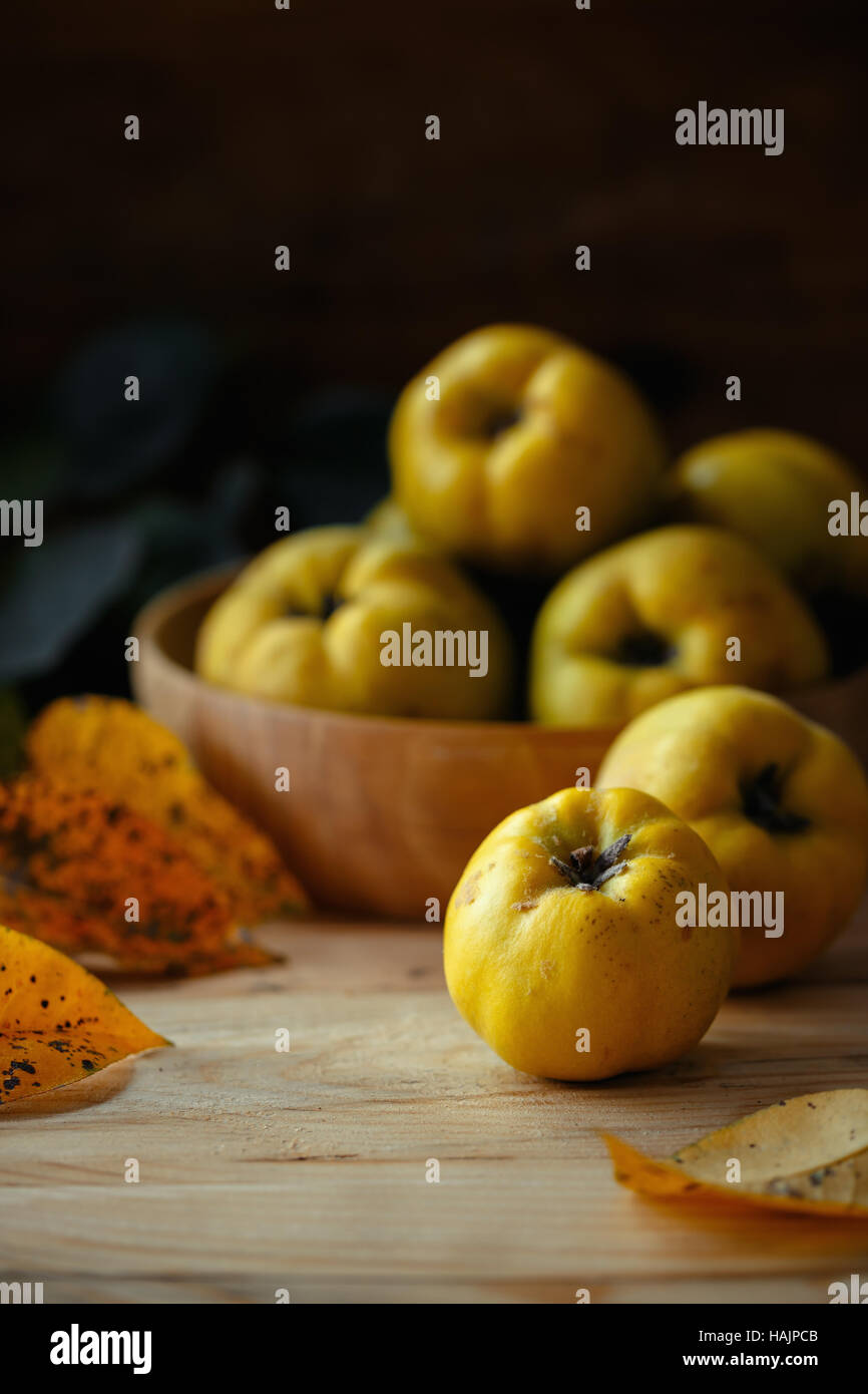 An autumn still life with quinces on wooden table Stock Photo