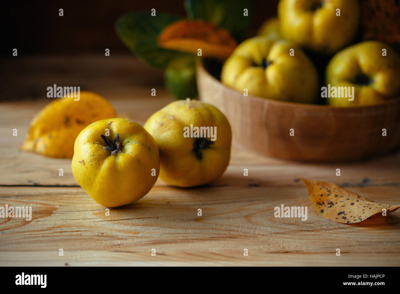 An autumn still life with quinces on wooden table Stock Photo