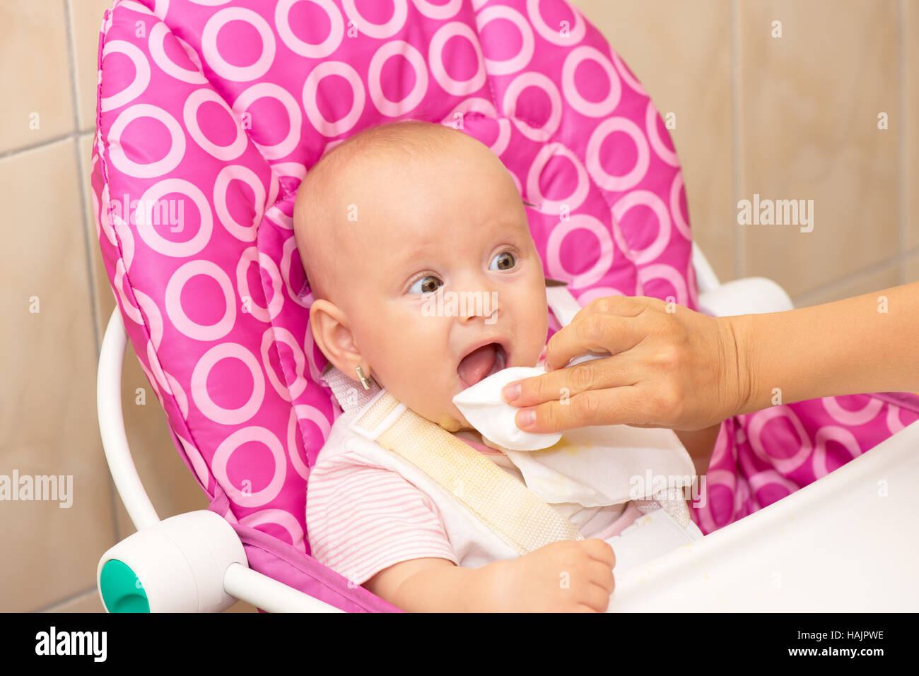 Mother cleaning baby's mouth Stock Photo