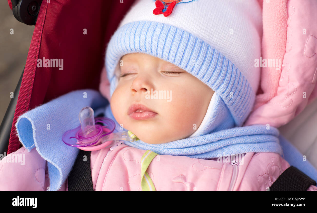 Muffled baby sleeping outdoor Stock Photo