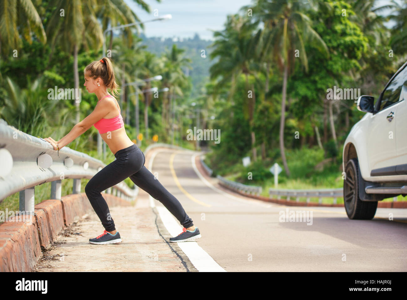 young fitness woman running at tropical forest trail Stock Photo - Alamy