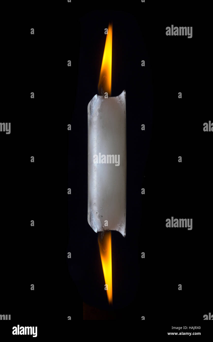 Burning a candle at both ends Stock Photo Alamy
