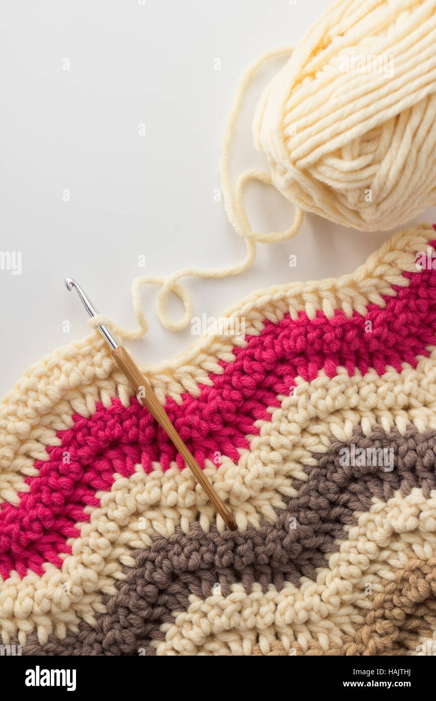 Crochet hook with crocheted blanket Stock Photo