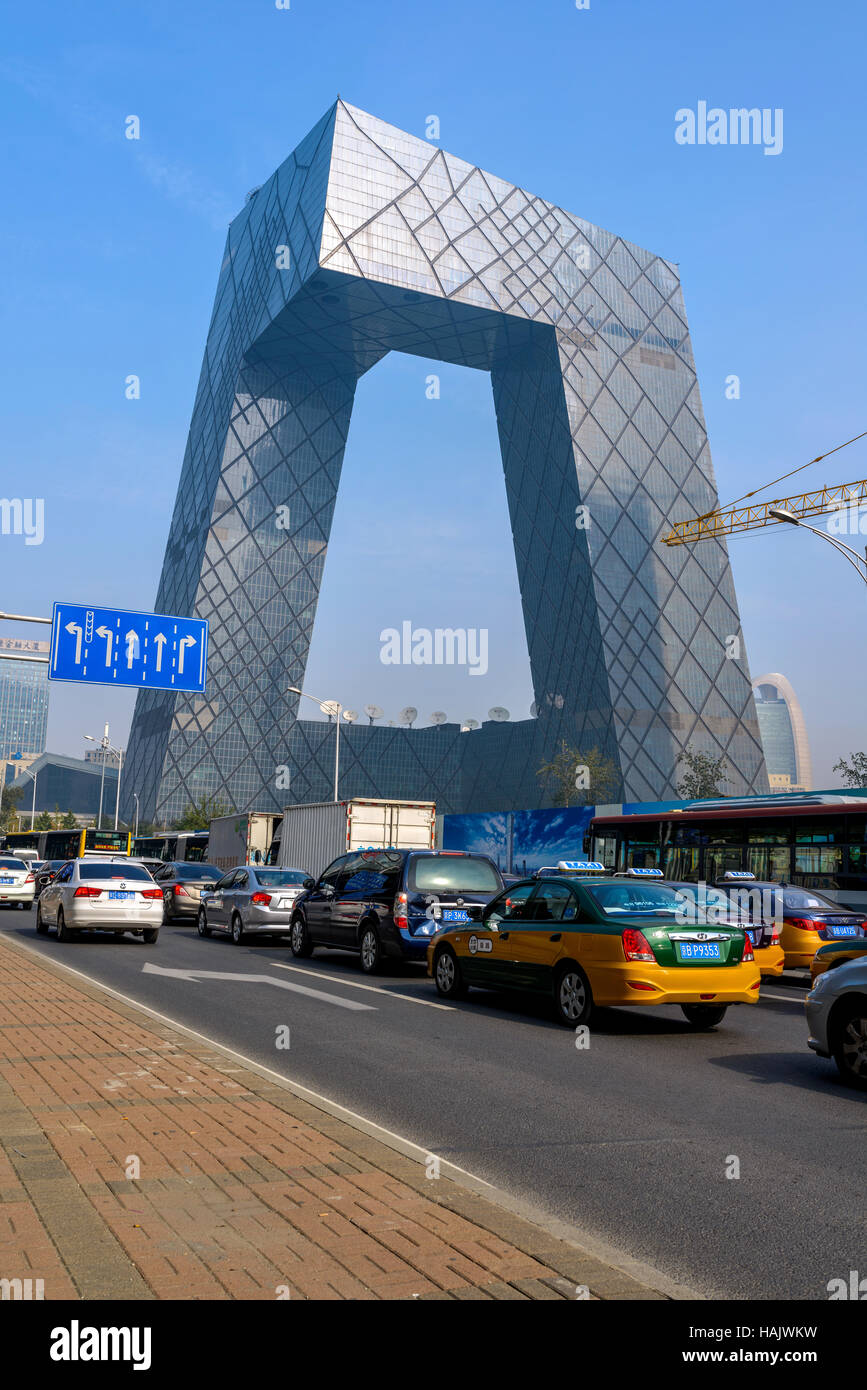 CCTV Headquarters - The heavy traffic on East Third Ring Road at front of the tower of China Central Television Tower, Beijing. Stock Photo
