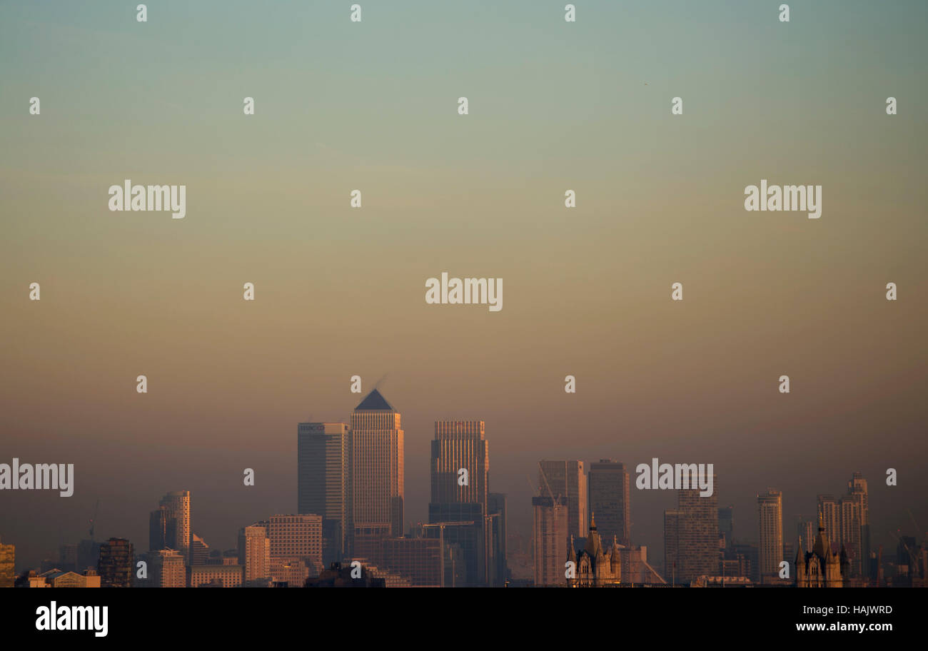 The sun sets over Canary Wharf in London, as today marks the start of the meteorological winter. Stock Photo