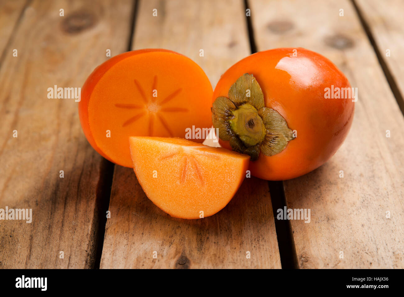 details persimmon fruit on rough wooden table Stock Photo