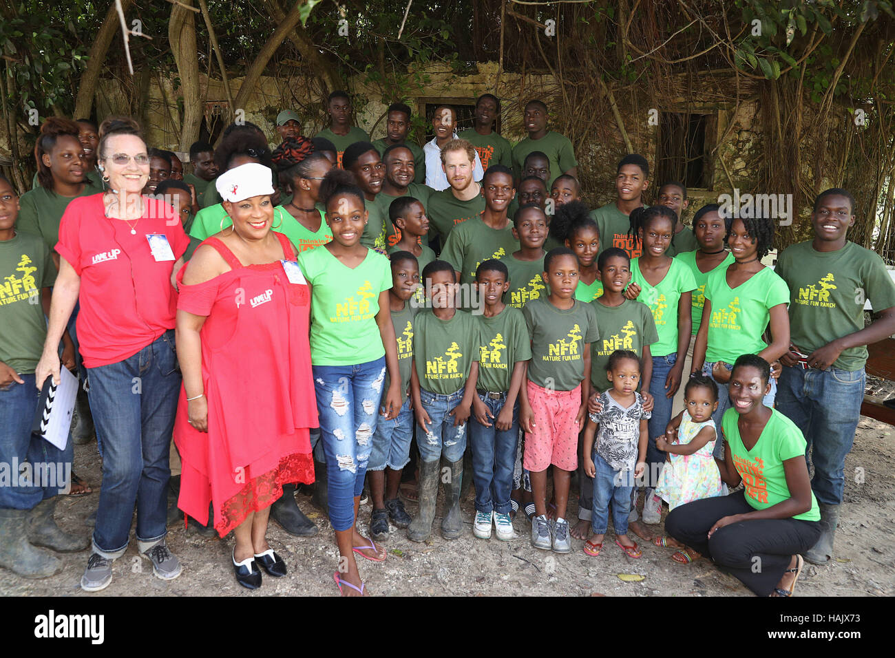 Prince Harry poses with volunteers during a visit to 'Nature Fun Ranch', which allows young people to speak freely with one another about important topics, including HIV/AIDS, providing them with a positive focus to guide their lives in the right direction, during his tour of the Caribbean. Stock Photo