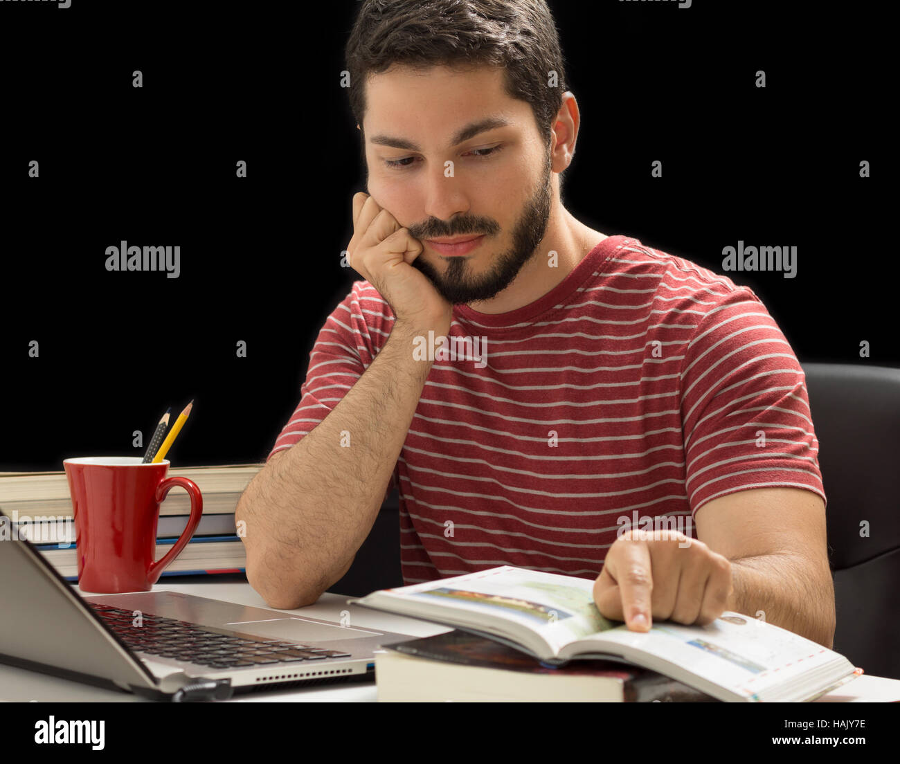 Male reading and pointing a book. Studies. Stock Photo