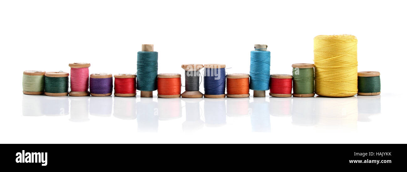 colorful thread bobbins isolated on white background Stock Photo