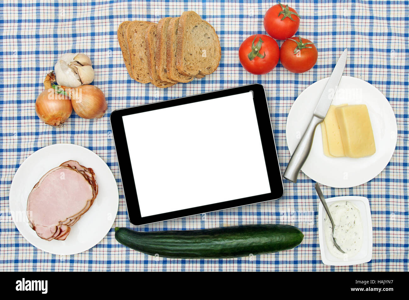 breakfast table with blank digital tablet in the center Stock Photo