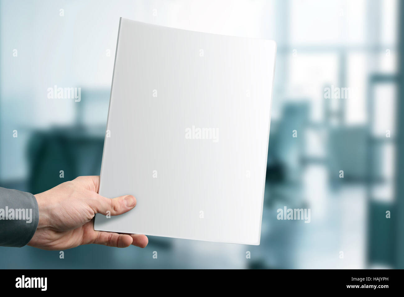 hand holding blank magazine with copy space at the office Stock Photo