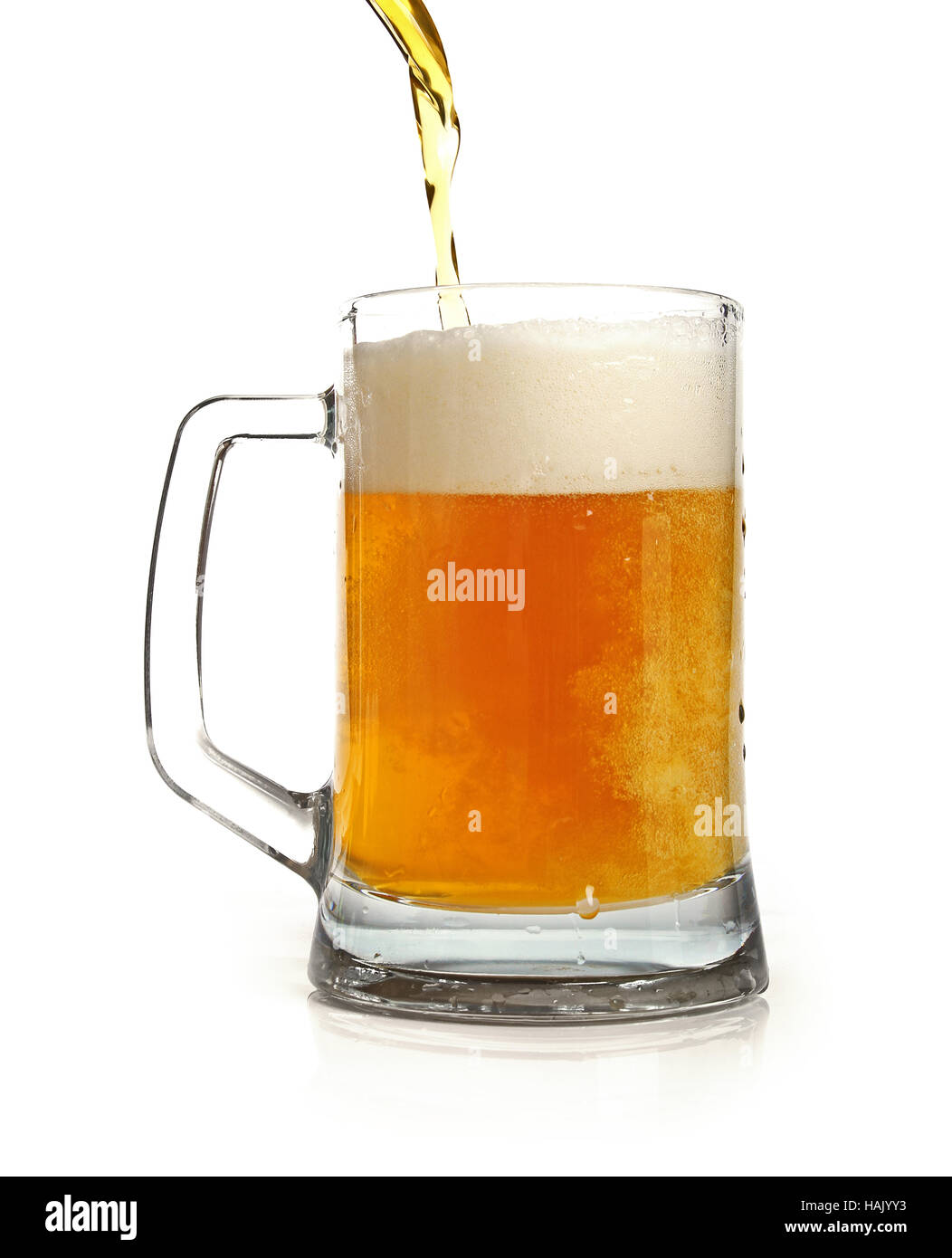 pouring beer in mug isolated on white Stock Photo