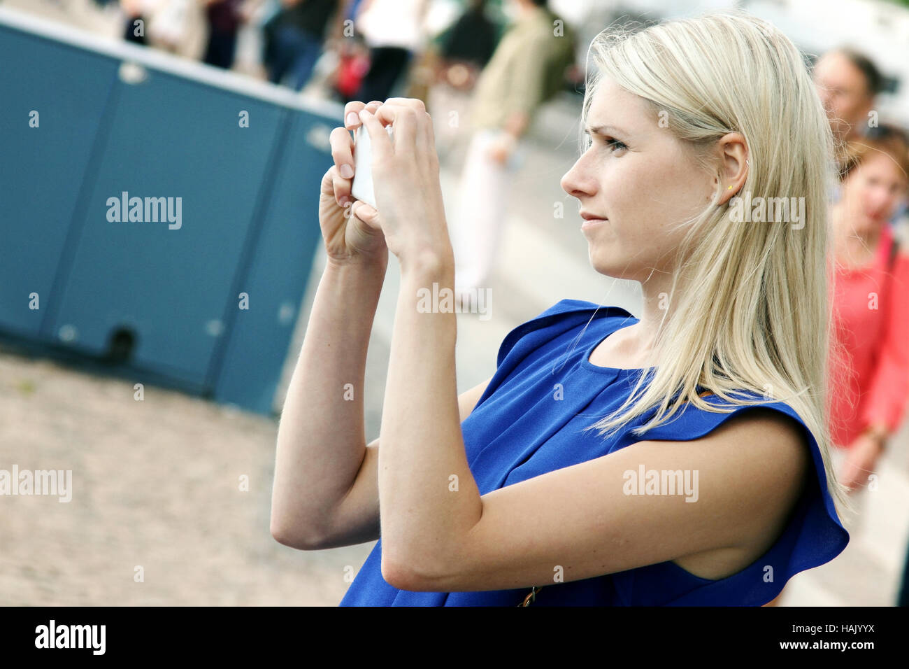 woman taking picture with mobile phone on the street Stock Photo
