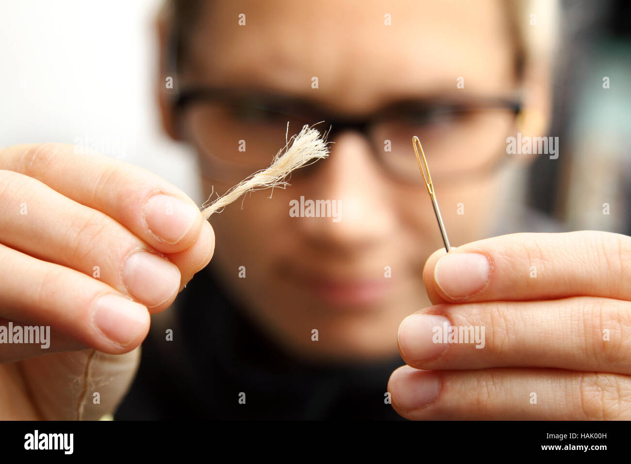 concept of persistence - needle and thread Stock Photo
