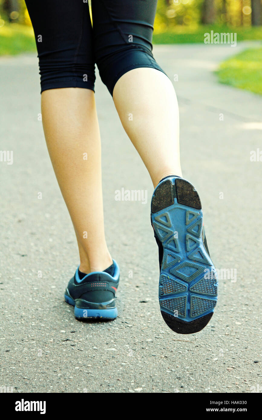 woman running on road, healthy lifestyle concept Stock Photo