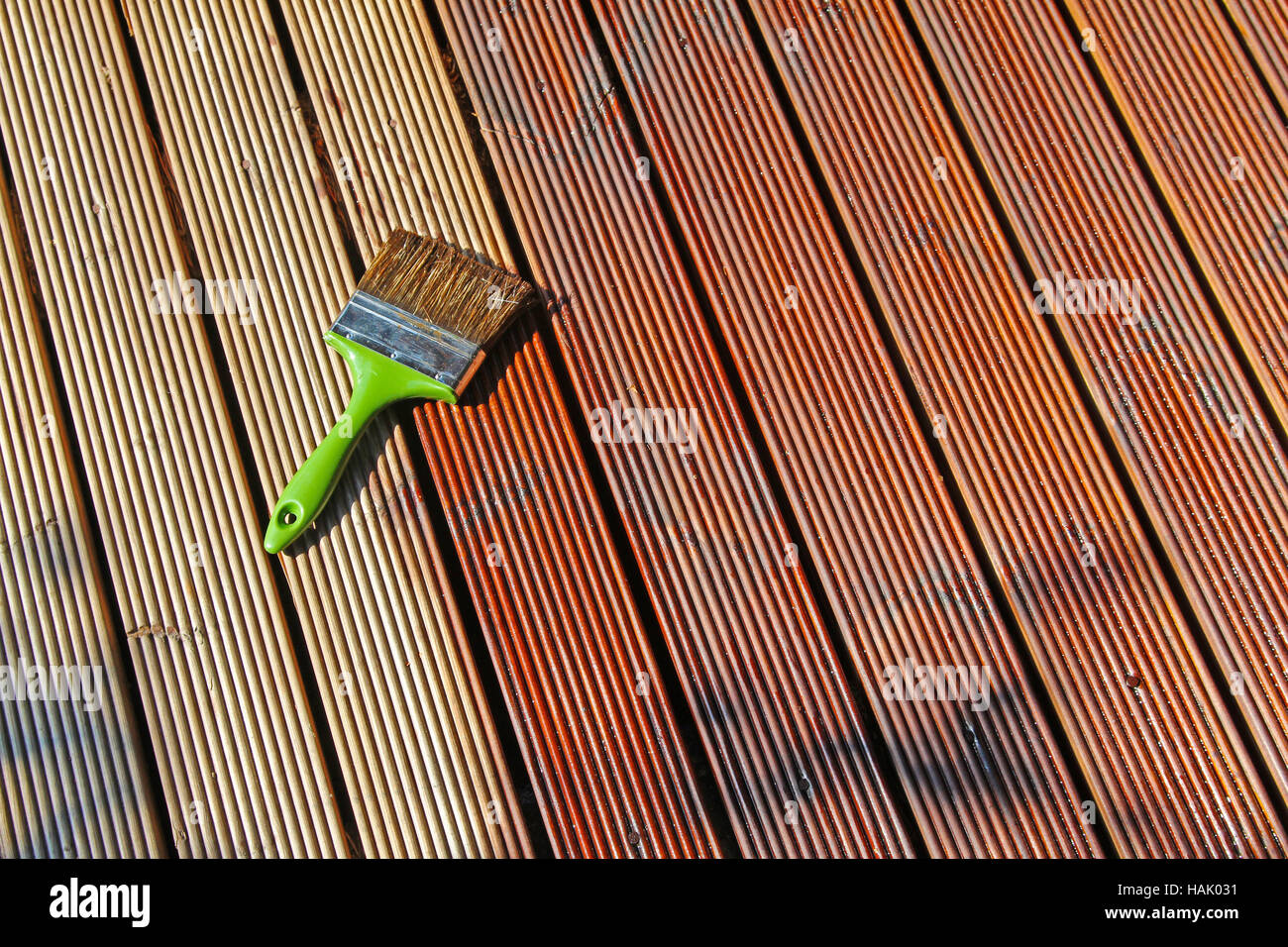 painting wooden patio deck with protective oil Stock Photo
