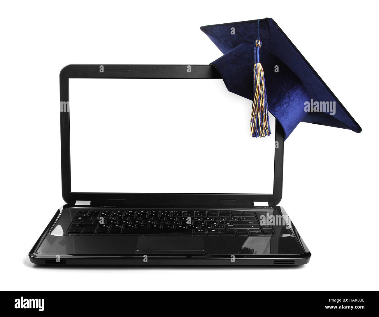laptop with blank screen and education student cap Stock Photo