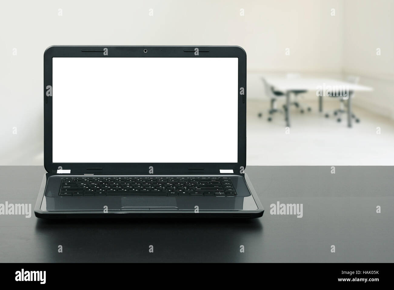 laptop with blank screen on wooden table in the office Stock Photo - Alamy