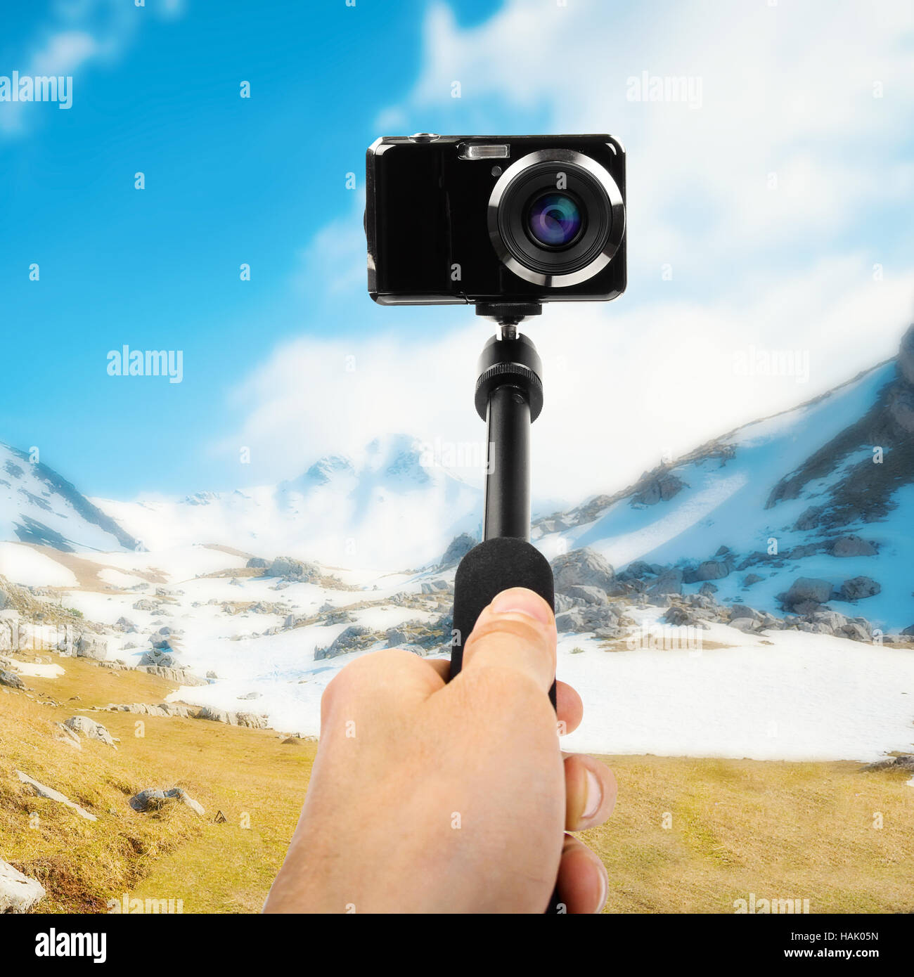 taking selfie - hand hold monopod with photo camera Stock Photo