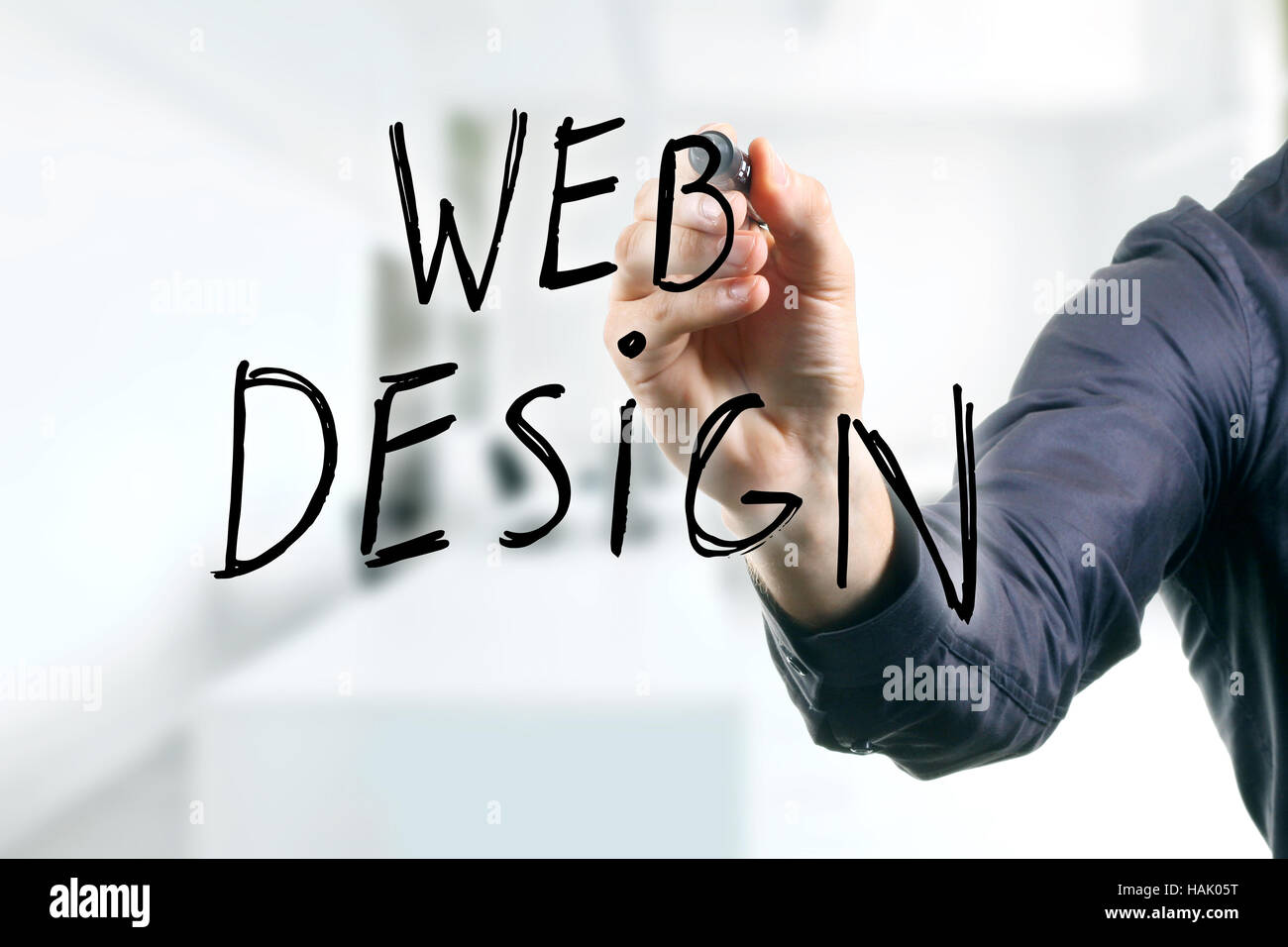 hand writing web design with black marker Stock Photo