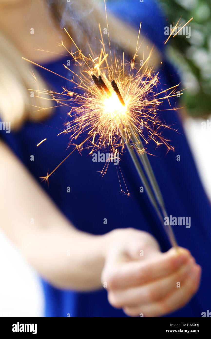 woman holding sparkler in her hand Stock Photo