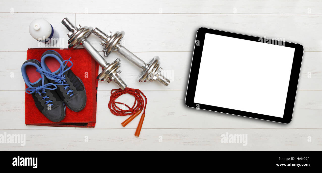 fitness equipment and blank digital tablet on gym floor Stock Photo