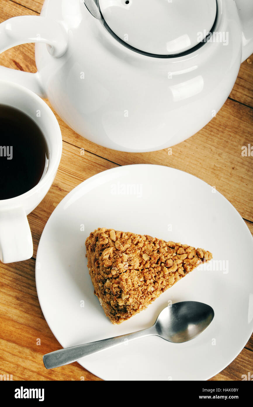piece of cake and cup of coffee on wooden table Stock Photo