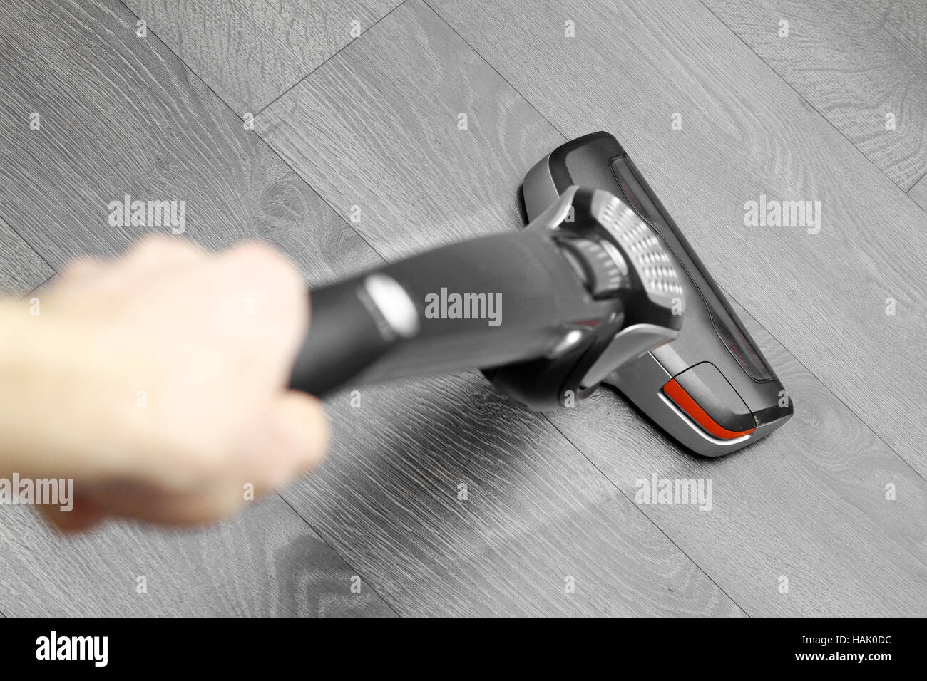 cleaning floor with cordless vacuum cleaner Stock Photo