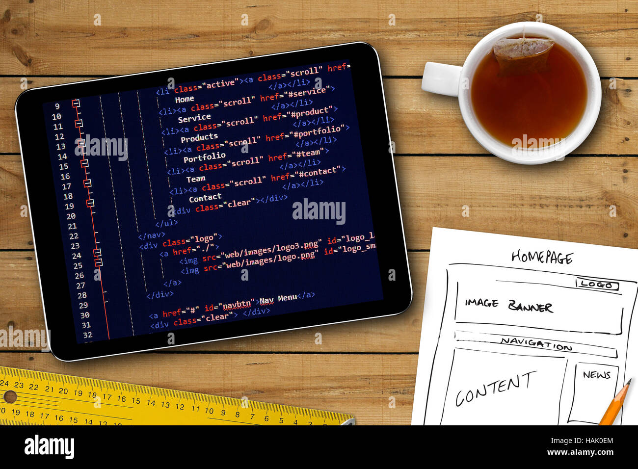 website wireframe sketch and programming code on digital tablet screen Stock Photo