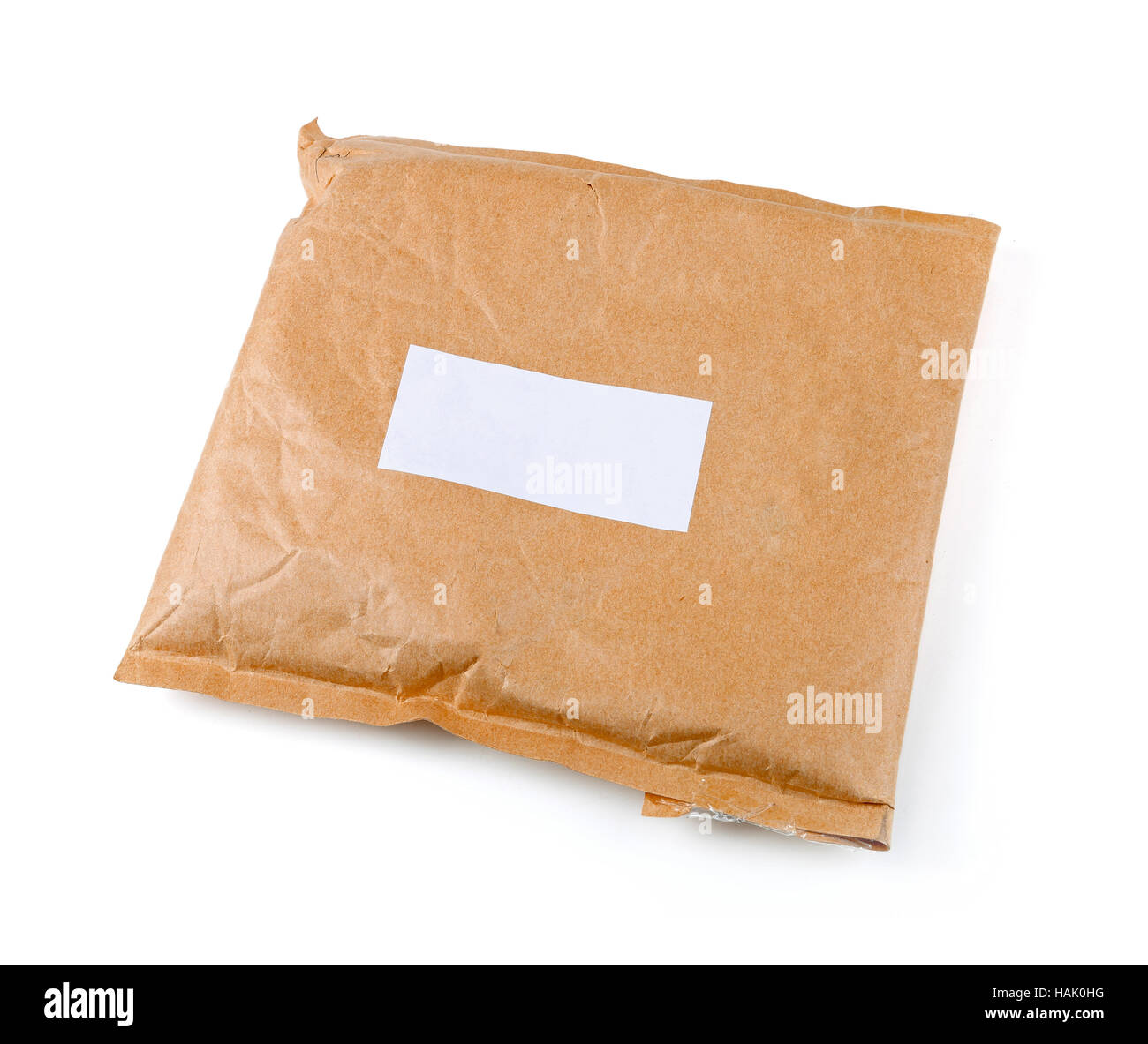 small paper post parcel with blank label isolated on white Stock Photo