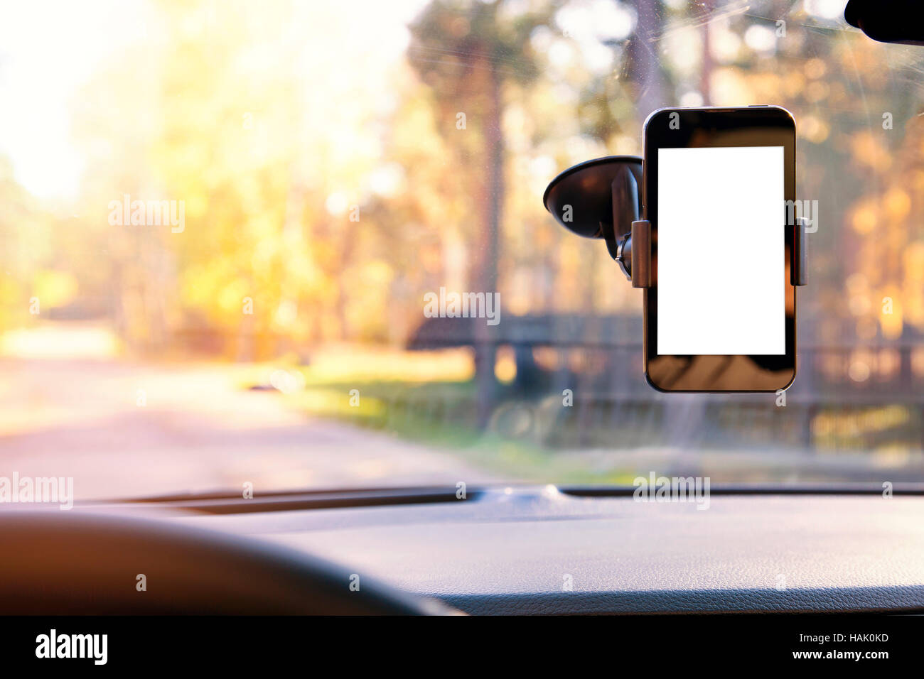mobile phone with blank screen in car windshield holder Stock Photo