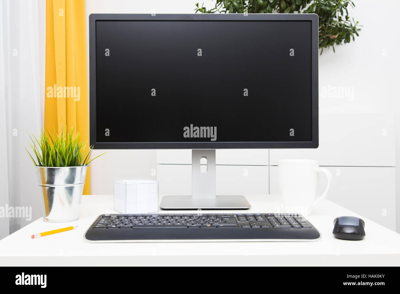 blank monitor on table in bright interior Stock Photo