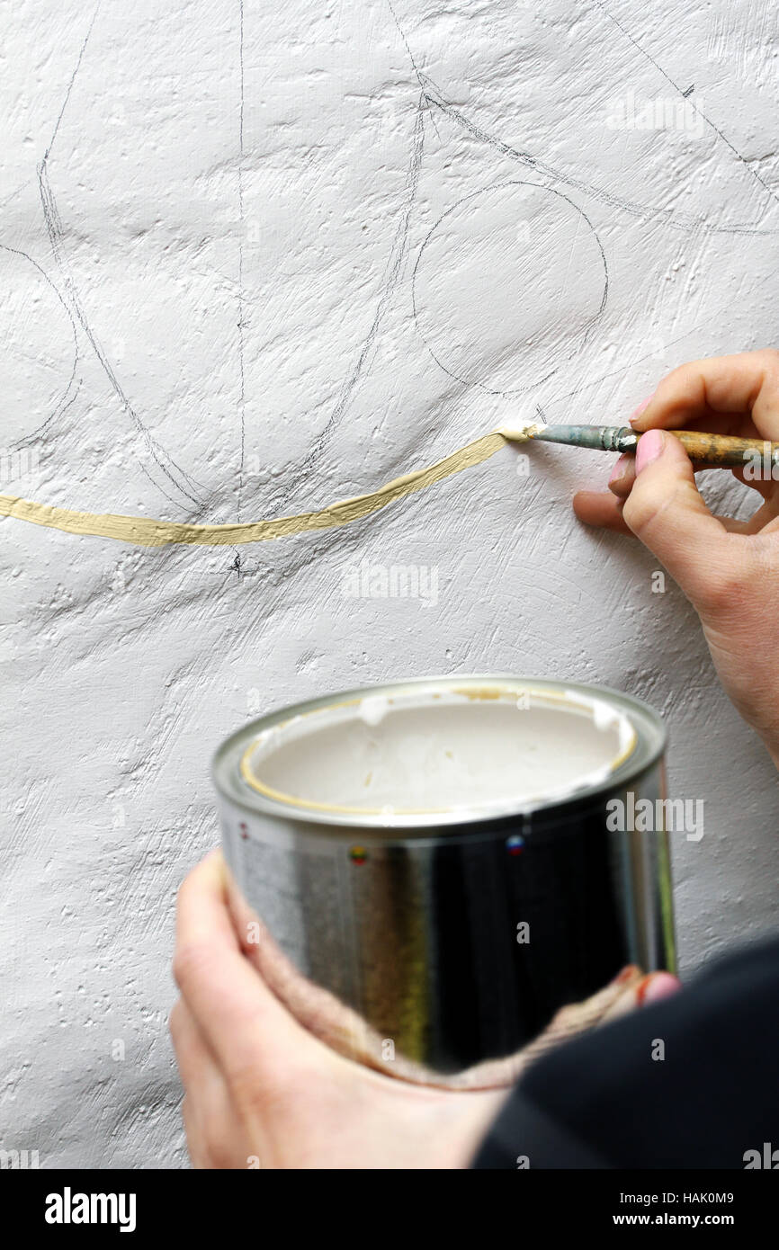 artist paints oil painting on the wall Stock Photo