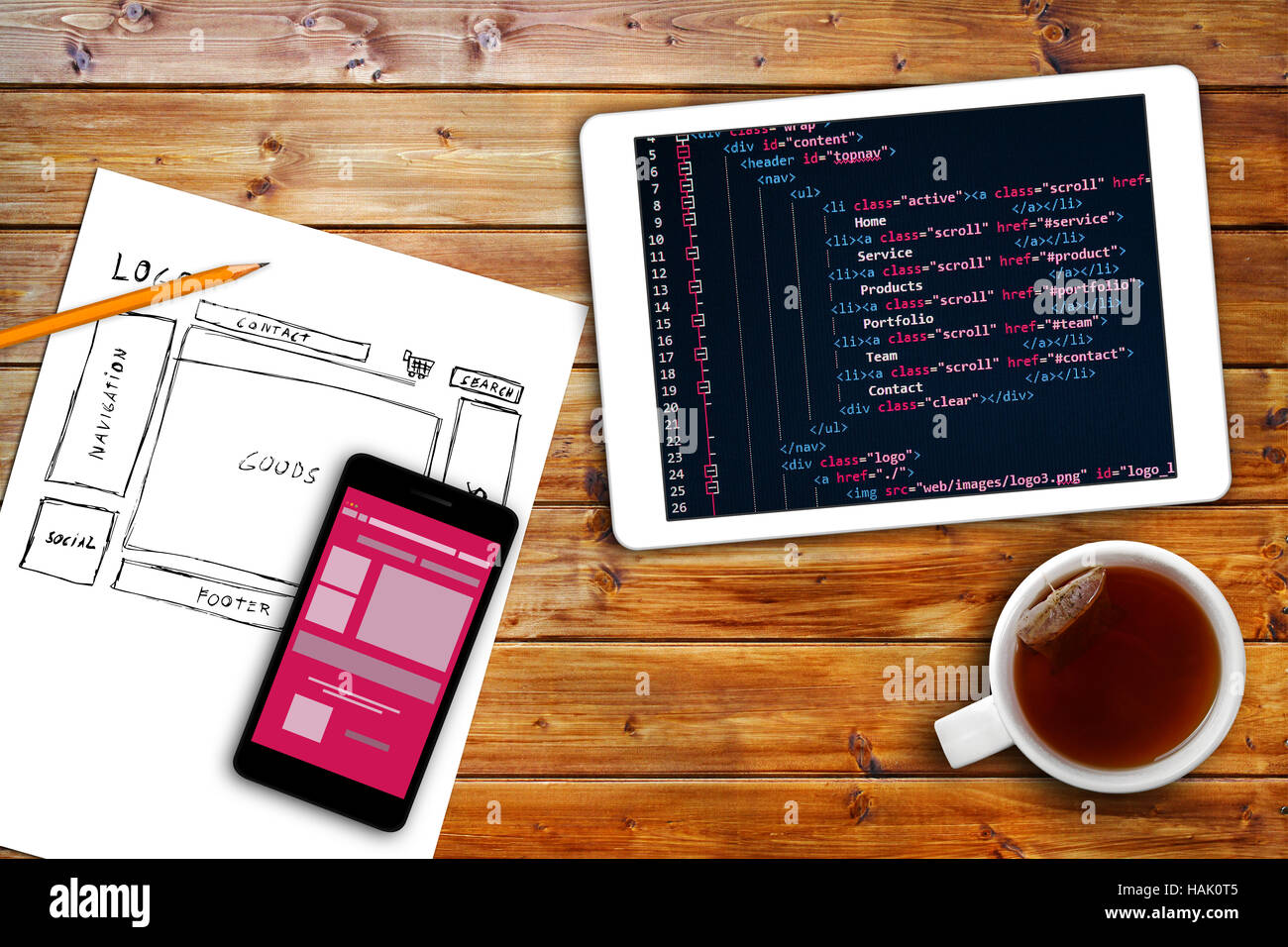 website wireframe sketch and programming code on digital tablet Stock Photo