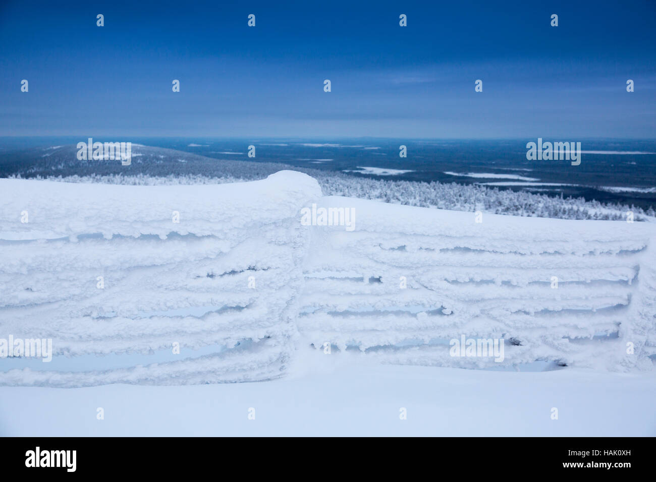 frozen fence covered with snow against mountains background Stock Photo ...