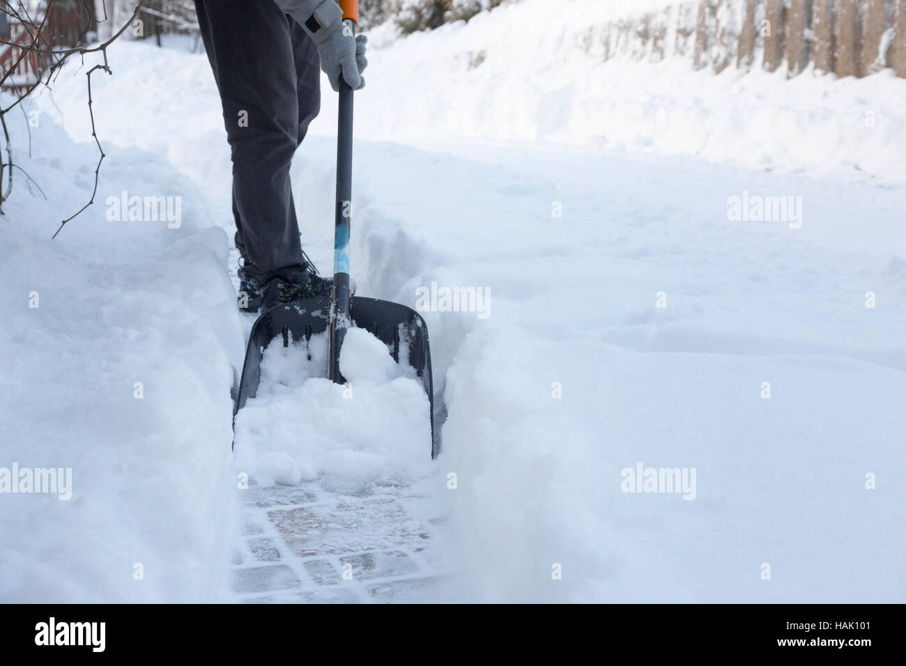 man shoveling snow away from walkway Stock Photo Alamy