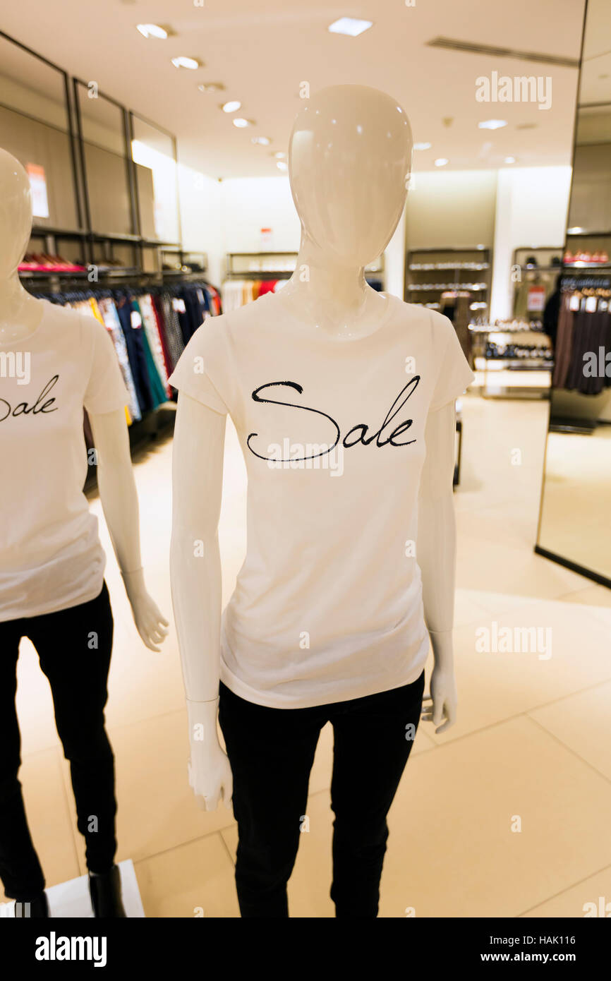 mannequin with sale t-shirt in clothes shop Stock Photo