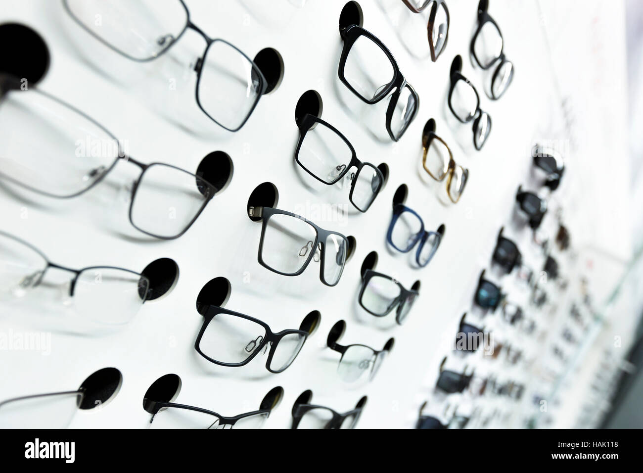 optical store, wall of many fashionable eyeglasses Stock Photo
