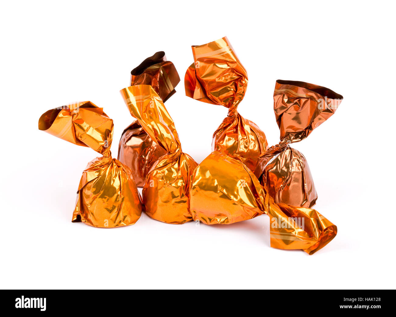 group of chocolate candies wrapped in shiny paper isolated on white Stock Photo