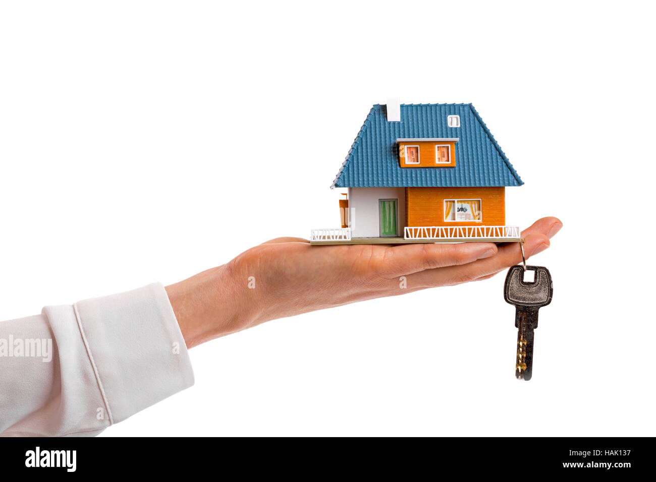 buying new real estate concept, small family house and key on woman's hand Stock Photo