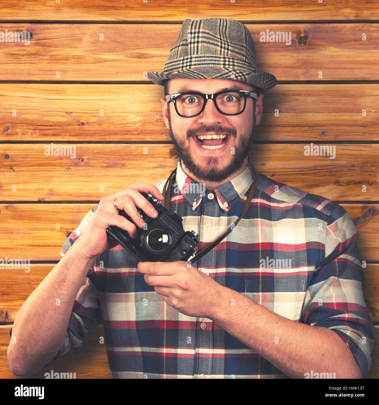 vintage style happy smiling hipster with retro camera in hands Stock Photo