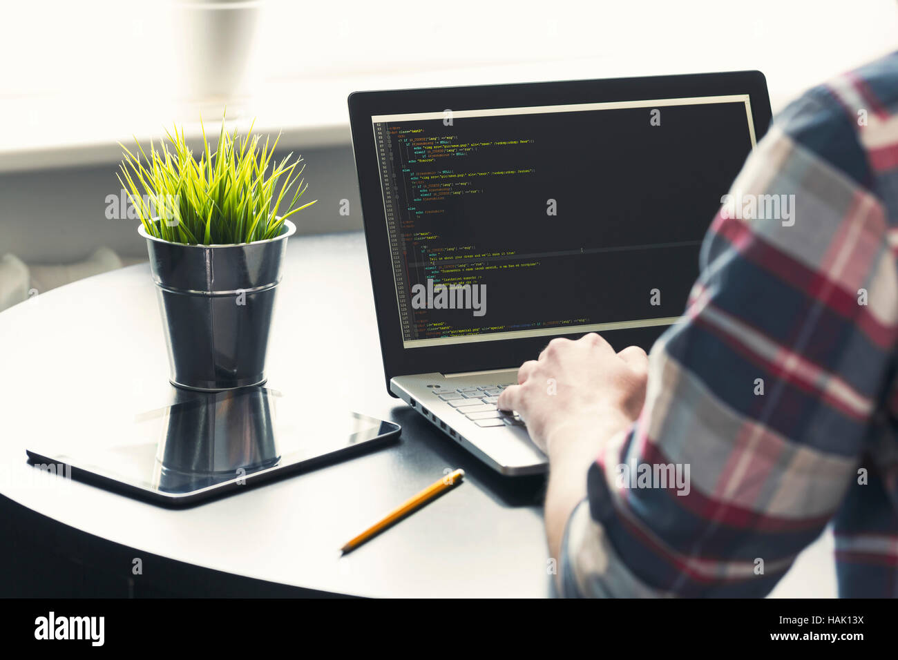 programmer working on laptop at office. focus on programming code Stock Photo