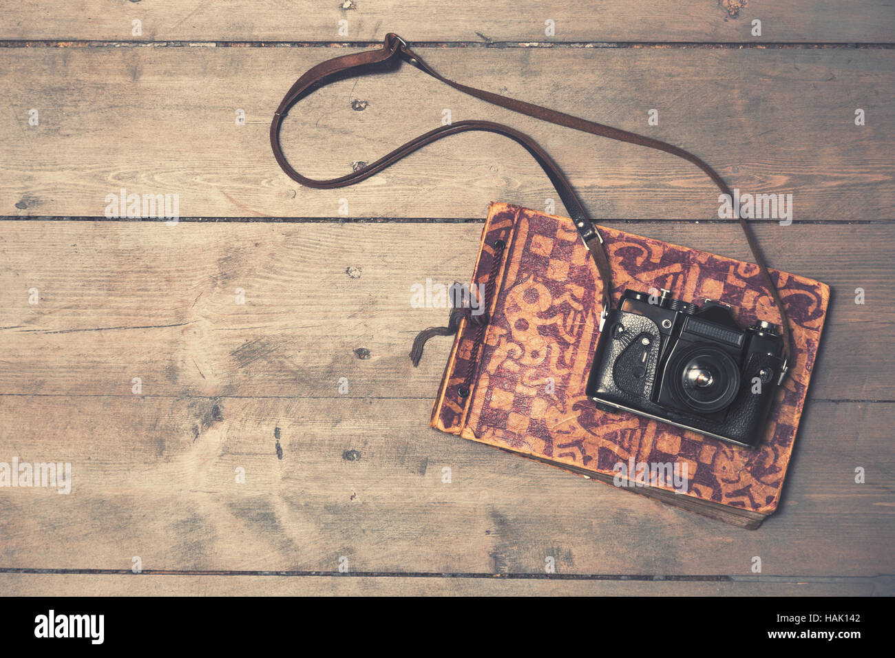 retro camera with vintage photo album on wooden background Stock Photo